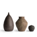 Three brown ceramic vases of different sizes on a white background