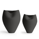 Two matte black sculptural ceramic vases of different sizes, displayed side-by-side on a clean white background.