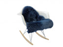 White rocking chair with a blue fur throw on a white background