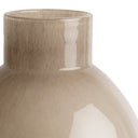 Close-up of a beige glass vase with a textured surface on a white background