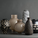 Collection of various ceramic vases on a dark background