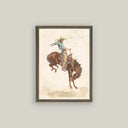 Framed vintage western art print of a rodeo cowboy riding a bucking bronco, in a dark wood frame.