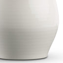 Close-up of a white ceramic lamp base on a light gray background