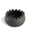 Ceramic bowl with textured rim on a white background