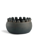 Ceramic bowl with small stones on a white background