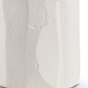 Close-up of white textured lamp base on a white background