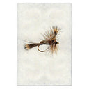 Fishing fly on a textured white background