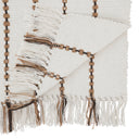 A close-up of a woven textile with fringe tassels and decorative bead-like accents in brown and beige tones.