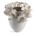 White ceramic vase with floral designs on a white background