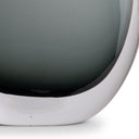 Close-up of a modern glass table lamp base with a curved design on a white background