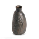 Bronze vase with textured surface on a white background