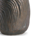 Close-up of a textured black ceramic vase on a white background
