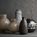 Collection of various ceramic vases on a dark background