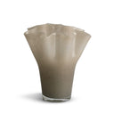 A fluted glass vase with a wavy rim, featuring a gradient color transition from a warm taupe-beige at the top to a darker gray-brown at the base, set against a plain white background.