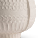 Close-up of a textured ceramic lamp base on a white background