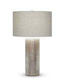 Kelly Table Lamp with textured cylindrical base and gray fabric shade on a white background