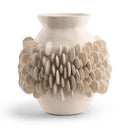 A ceramic vase with a matte, warm off-white finish, featuring a textured design with a smooth central body and a surrounding cluster of overlapping, petal-like protrusions, set against a plain white background.
