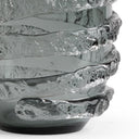 Close-up of a textured glass lamp base on a white background