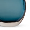Close-up of a blue glass table lamp base with a metallic base on a white background