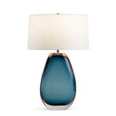 Blue glass table lamp with a white shade on a white background
