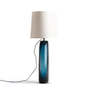 Floor lamp with blue glass base and beige lampshade on a white background