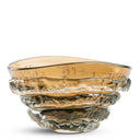 A hand-blown amber glass bowl with a textured, layered base, shown on a clean white background.