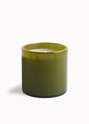 An olive green glass jar candle with a gold-toned rim and white wax inside, photographed on a clean white background.
