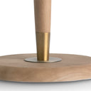 Close-up of a wooden and brass table lamp base on a white background