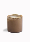 A brown textured glass jar candle with a gold rim and white wax inside, photographed on a clean white background.