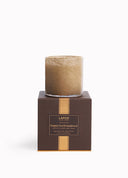 A LAFCO New York candle in a clear glass vessel with a textured tan wax top, presented on a dark brown square box with gold accents. The box features the brand name 'LAFCO NEW YORK' and the scent name 'Pumpkin Seed & Sandalwood'.