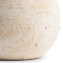 Close-up of a textured beige stone lamp base.