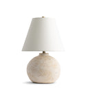 Roscoe Table lamp with a textured ceramic base and white shade on a white background
