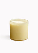 Yellow candle in a glass container on a white background