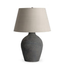 Theo Table Lamp with a textured gray base and beige lampshade on a white background