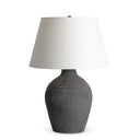 Theo Table Lamp with a textured gray base and white shade on a white background
