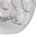 Close-up of a clear glass decorative object with a rounded, bubble-like textured surface on a white background.