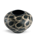 Black ceramic vase with beige circular patterns on a white background